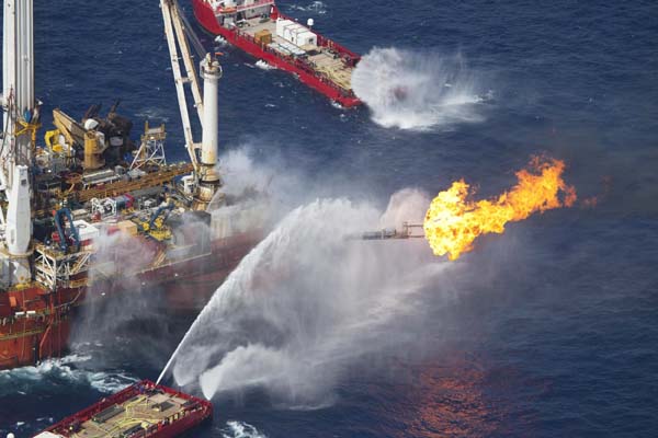 The Q4000 multi-purpose oil field intervention vessel burns off material from the Deepwater Horizon wellhead near the disaster site in this June 22, 2010 handout photo. [Xinhua/Reuters]