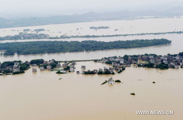 Photo taken on June 22, 2010 shows the aerial view of the boundless expanse of deluge that inundate the villages, located to the proximity of the bursted dyke of Fuhe River, in Yujiang County, east China's Jiangxi Province. The dike at the Changkai section of the Fuhe River burst late Monday. [Xinhua]