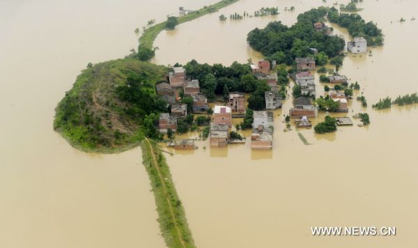 Photo taken on June 22, 2010 shows the aerial view of the boundless expanse of deluge that inundate the village, located to the proximity of the bursted dyke of Fuhe River, in Yujiang County, east China's Jiangxi Province. The dike at the Changkai section of the Fuhe River burst late Monday. The local Flood Control and Drought Relief Office says the opening in the dike has expanded to 400 meters Tuesday. More than 1,200 people have been rescued after the Fuhe River burst its bank and flooded parts of Fuzhou City. The floods are the worst for 50 years and over 25 million people have been affected. (Xinhua/Tian Jingyue) (px) 