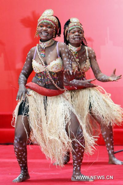 Performers dance during activities marking the National Pavilion Day of the Democratic Republic of the Congo in the World Expo Park in Shanghai, east China, on June 23, 2010. The National Pavilion Day of the Democratic Republic of the Congo is celebrated on Wednesday. 
