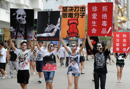 College students hold billboards for an anti-drug campaign in Hefei, East China's Anhui province on June 23, ahead of International Day Against Drug Abuse and Illicit Trafficking.