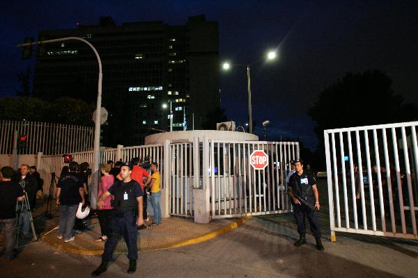 Police guard the entrance to the Greek Citizen Protection Ministry in Athens after a parcel bomb attack on June 24, 2010. Greek Citizen Protection Minister Michalis Chrisohoidis confirmed on Thursday evening that one police officer died during an unprecedented terrorist attack inside the building of the ministry. [Marios Lolos/Xinhua]