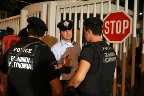 Police stand guard at the entrance of the Greek Citizen Protection Ministry building on June 24, 2010. [Xinhua]