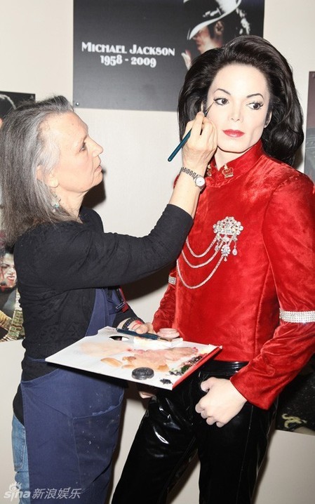 Artist Morfy Gikas touches up the Michael Jackson tribute exhibit at Madame Tussauds wax museum in New York June 23, 2010 ahead of the one year anniversary of Jackson's death on June 25.