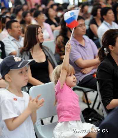 A little girl waves Slovenian national flag during activities marking the National Pavilion Day of Slovenia in the World Expo Park in Shanghai, east China, on June 24, 2010. The National Pavilion Day of Slovenia was celebrated on Thursday. 