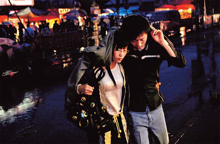 A young couple make their way home in Tangjialing. Many young urban couples live in the Beijing village. 