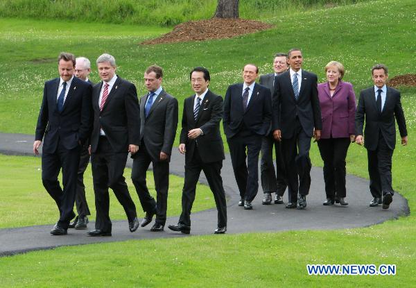 Canadian Prime Minister Stephen Harper (front R) is flanked by G-8 leaders as they stroll down a path on their way to pose for the leaders' group photo at the G-8 Summit in Huntsville, Ontario, on June 25, 2010. 