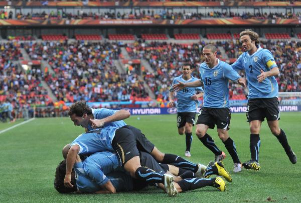 Uruguay's players celebrate their scoring during the 2010 World Cup round of 16 soccer match against South Korea at Nelson Mandela Bay stadium in Port Elizabeth, South Africa, on June 26, 2010. (Xinhua/Chen Haitong)