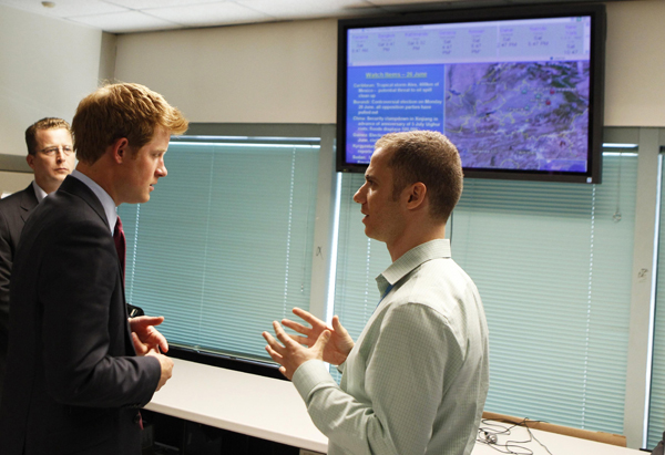 Britain&apos;s Prince Harry (L) speaks with Paul Farrell, manager of the UNICEF Office of Emergency Programme Operations Center, while touring UNICEF offices during his visit to New York June 26, 2010. [Xinhua/Reuters]