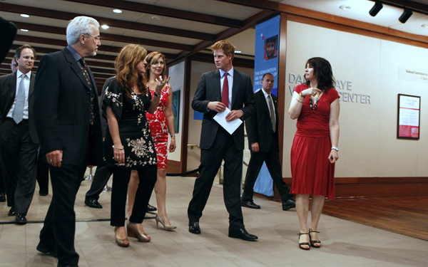 Britain&apos;s Prince Harry (C) speaks to UNICEF personnel while on a tour of the UNICEF offices during his visit to New York June 26, 2010. [Xinhua/Reuters]