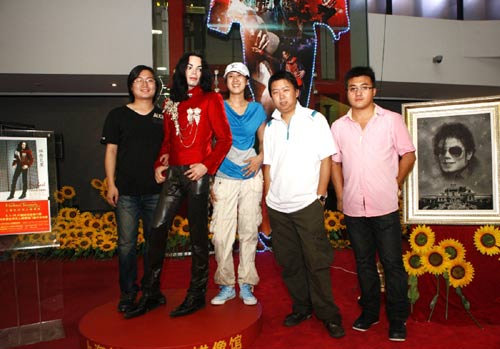 Visitors pose with the Michael Jackson tribute exhibit at the Shanghai World Expo, June 25, 2010. 