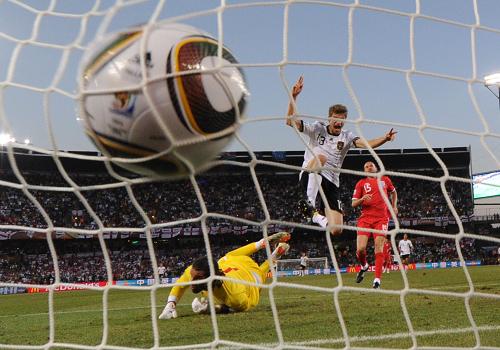 Germany's Thomas Mueller (L) celebrates after scoring the fourth goal past England's goalkeeper David James during their 2010 World Cup second round soccer match at Free State stadium in Bloemfontein June 27, 2010.