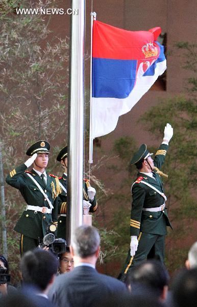 Serbia's national flag is raised during a ceremony marking the Serbia National Pavilion Day at the Shanghai World Expo in Shanghai, east China, June 27, 2010. 