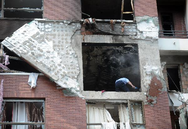 A man works at the blast site in Changchun, northeast China&apos;s Jilin Province, on June 28, 2010. The blast occurred in a building of Changyingshiji village in Changchun caused fire and left one dead and six injured. Now the cause of the blast is under investigation. [Xinhua]