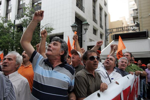 Greek protesters stage a protest in front of Greek Finance Ministry against austerity measures in Athens, capital of Greece, on June 28, 2010. The demonstration was held ahead of a 24-hour nationwide general strike planned on June 29 by the two main labor unions of public and private sector employees in Greece. [Marios Lolos/Xinhua]