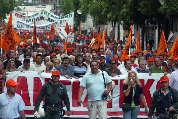 Greek protesters stage a protest in front of Greek Finance Ministry against austerity measures in Athens, capital of Greece, on June 28, 2010. The demonstration was held ahead of a 24-hour nationwide general strike planned on June 29 by the two main labor unions of public and private sector employees in Greece. [Marios Lolos/Xinhua]