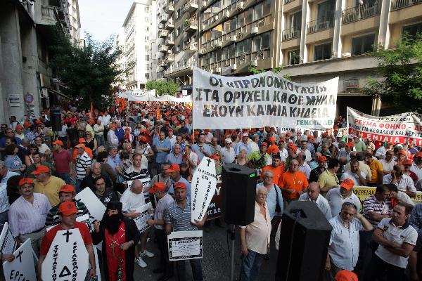 Greek protesters stage a protest in front of Greek Finance Ministry against austerity measures in Athens, capital of Greece, on June 28, 2010. The demonstration was held ahead of a 24-hour nationwide general strike planned on June 29 by the two main labor unions of public and private sector employees in Greece. [Marios Lolos/Xinhua]