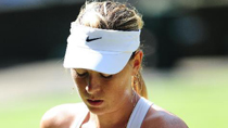 Maria Sharapova of Russia reacts during her fourth round match of women's singles against Serena Williams of the United States at the 2010 Wimbledon Tennis Championships in London, Britain, June 28, 2010. Sharapova lost 0-2.