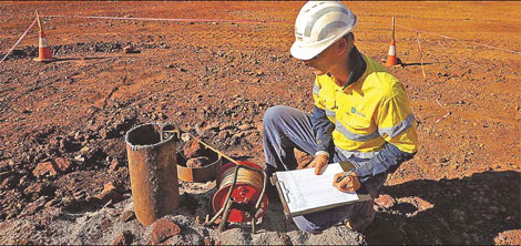 A hydro geologist measures groundwater readings while performing an underground pump test in the South Limb pit at Atlas Iron's mine in Pardoo, east of Port Hedland in the Pilbara region of Western Australia. [China Daily]