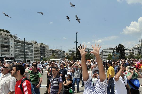 A Greek striker gestures against the Parliament during a demonstration in central Athens Tuesday June 29, 2010. (Xinhua/AFP Photo)