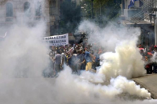 Policemen spray teargas at attacking protesters during a demonstration of over 10,000 people in central Athens June 29, 2010. (Xinhua/AFP Photo)