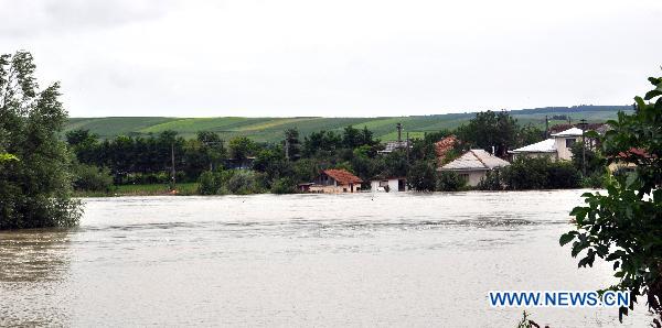 Roads and farmland are submerged after Jijia river flooding due to heavy rains in Botosani in northeast of Romania, June 30, 2010. Floods in recent days have claimed 22 lives in Romania and more than 7,000 people were forced to flee their homes to safety, according to the official data presented Wednesday. [Agerpres/Xinhua]
