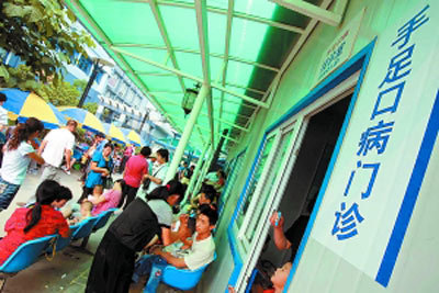 Parents take children to see doctors in the Beijing Children's Hospital on June 29, 2010. Hand-foot-mouth disease (HFMD) has claimed nine lives in Beijing this year, with two new deaths reported from June 21 to 27.