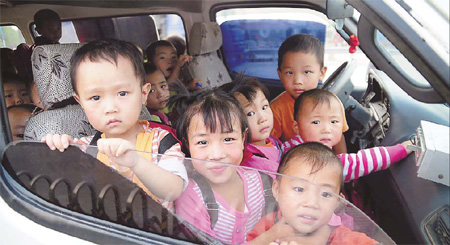Some of the 59 children who were crammed into an 11-seater minivan that was recently pulled over by traffic police in Nanyang, Henan province. The children, all primary and kindergarten pupils, were accompanied by a teacher. Police say overcrowding and poor conditions on school buses across the country are risking lives. 