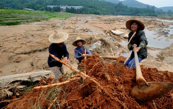 Villagers repair a road at Gaobu Village of Wangtai Township in Nanping City, southeast China's Fujian Province, June 30, 2010. 