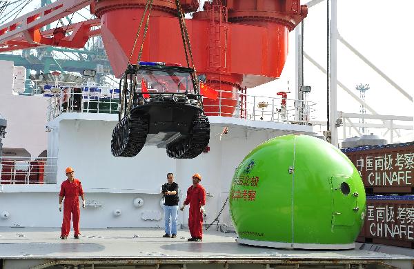 Crew members work on the deck of the icebreaker Xuelong, or 'Snow Dragon', the carrier for China's fourth scientific Arctic expedition, in Xiamen, southeast China's Fujian Province, on June 30, 2010. The Xuelong will set out on July 1. 