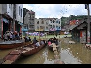 Luolou Township in Southwest China's Guangxi Zhuang autonomous region witnessed the largest rainfall in 300 years from June 27 to 29, leaving the region completely isolated by the flood. Schools in Luolou are closed, 6,673 people are affected, and local citizens have to travel by boat. [Xinhua] 