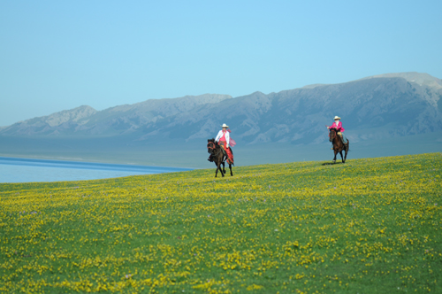 Riders give their horses free rein as they take in the beauty of the prairies around Sailimu Lake.