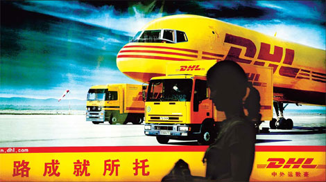A pedestrian walks in front of a DHL billboard in Guangzhou. DHL reported revenue totaling 33.7 billion euros ($41.38 billion) globally in 2009.[China Daily]