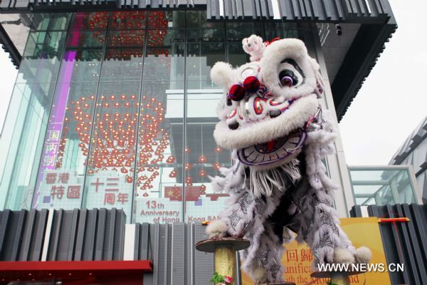Hong Kong actors perform lion dance to commemorate the 13th anniversary for Hong Kong's return to motherland in front of the Hong Kong pavilion at the Shanghai World Expo in Shanghai, east China, July 1, 2010. 