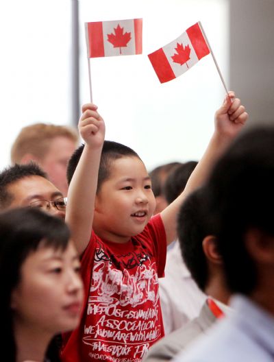 A boy waves national flag of Canada during a ceremony marking the Canada National Pavilion Day at the Shanghai World Expo in Shanghai, east China, July 1, 2010. 