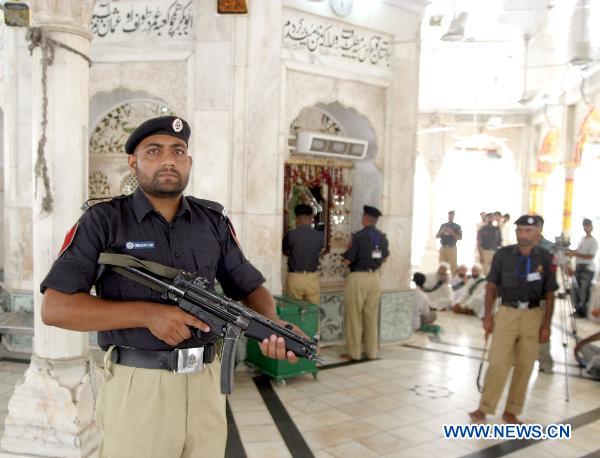 Policemen guard at the blast site in eastern Pakistani city of Lahore on July 2, 2010. [Jamil Ahmad/Xinhua]