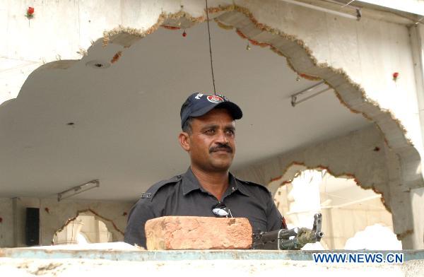 A policeman guards at the blast site in eastern Pakistani city of Lahore on July 2, 2010. [Jamil Ahmad/Xinhua]