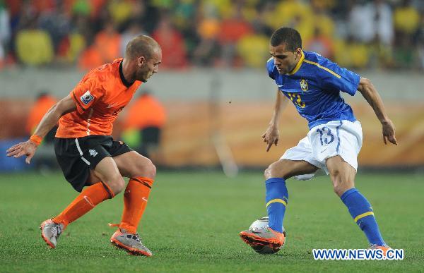 Dani Alves (R) of Brazil is defended by a player of the Netherlands during their 2010 World Cup quarter-final soccer match at Nelson Mandela Bay stadium in Port Elizabeth, South Africa, on July 2, 2010. Netherlands won 2-1 and is qualified for the semi-finals.