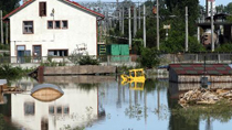 A girl rests on the sand bags at the banks of Danube River in Galati of Romania, July 3, 2010. Twenty-three people died in the severe floods that hit Romania over the past two weeks and thousands have been evacuated from their homes.