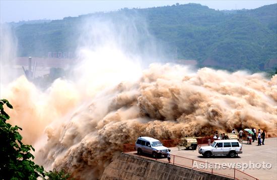 Spectators watch the desilting process at Xiaolangdi Reservoir on the Yellow River on July 4, 2010. [China Daily/Asianewsphoto] 