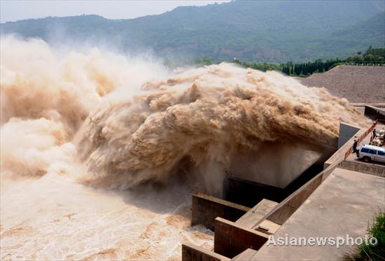 Spectators watch the desilting process at Xiaolangdi Reservoir on the Yellow River on July 4, 2010.[China Daily/Asianewsphoto] 