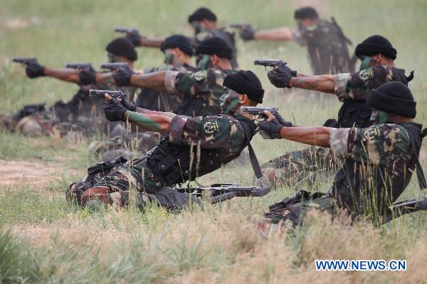 Chinese soldiers demonstrate shooting skills during a Chinese-Pakistani joint anti-terrorism drill in Qingtongxia of northwest China&apos;s Ningxia Hui Autonomous Region July 4, 2010. [Wang Jianmin/Xinhua]