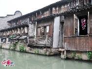 With a history of 1,200-year, Wuzhen is about one hour's drive from Hangzhou,the capital of Zhejiang Province.The small town is famous for the ancient buildings and old town layout, where bridges of all sizes cross the streams winding through the town. [Photo by Xiaoyong]