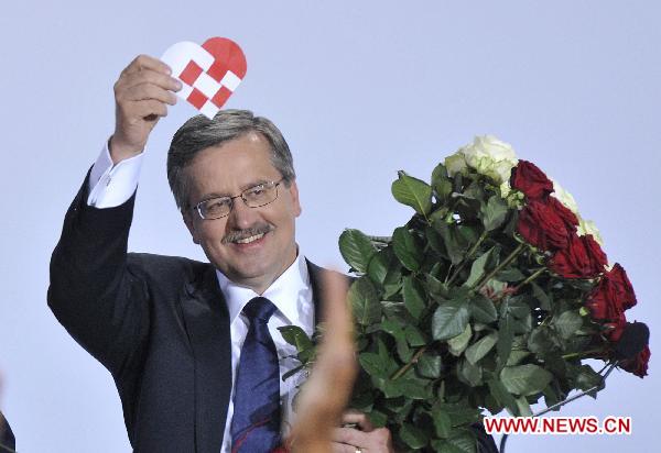 Bronislaw Komorowski, the candidate of Poland&apos;s ruling Civic Platform party (PO), gestures following the exit polls for the second round of presidential elections at his Party election headquarters in Warsaw, Poland, on July 4, 2010.