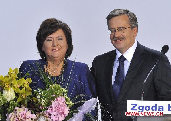 Bronislaw Komorowski (R), the candidate of Poland&apos;s ruling Civic Platform party (PO), celebrates with his wife following the exit polls for the second round of presidential elections at his Party election headquarters in Warsaw, Poland, on July 4, 2010.