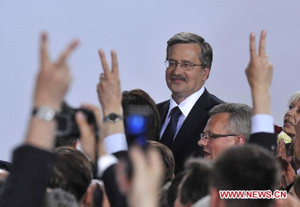 Bronislaw Komorowski, the candidate of Poland&apos;s ruling Civic Platform party (PO), is congratulated by his supporters following the exit polls for the second round of presidential elections at his Party election headquarters in Warsaw, Poland, on July 4, 2010.