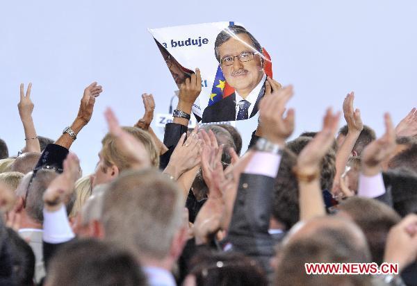 Bronislaw Komorowski, the candidate of Poland&apos;s ruling Civic Platform party (PO), is congratulated by his supporters following the exit polls for the second round of presidential elections at his Party election headquarters in Warsaw, Poland, on July 4, 2010.