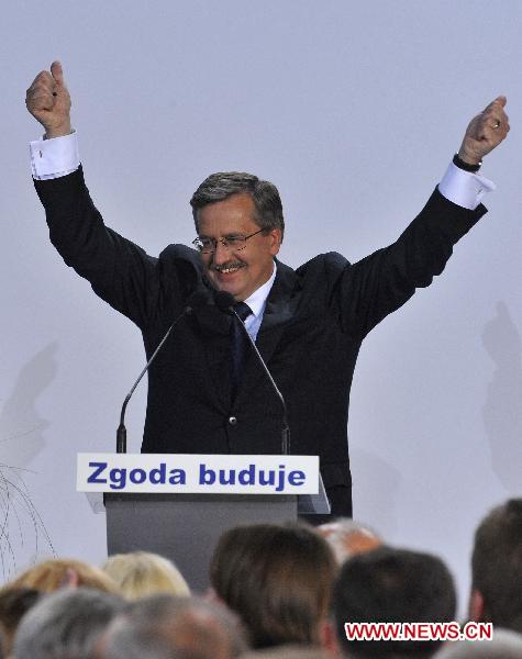 Bronislaw Komorowski, the candidate of Poland&apos;s ruling Civic Platform party (PO), is congratulated by his supporters following the exit polls for the second round of presidential elections at his Party election headquarters in Warsaw, Poland, on July 4, 2010.