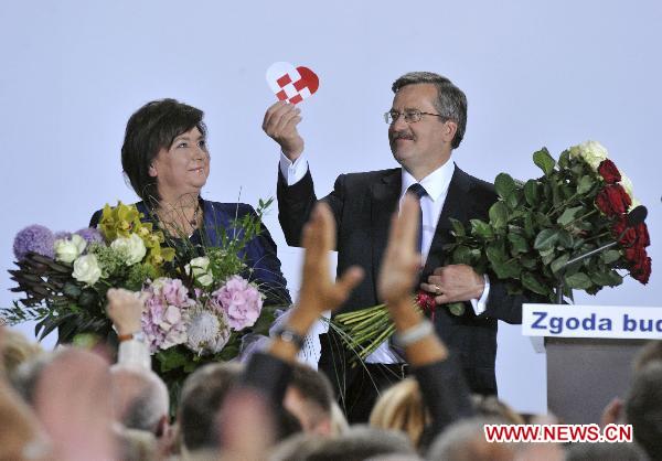 Bronislaw Komorowski, the candidate of Poland&apos;s ruling Civic Platform party (PO), is congratulated by his supporters following the exit polls for the second round of presidential elections at his Party election headquarters in Warsaw, Poland, on July 4, 2010.