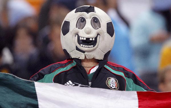 A Mexico fan wearing a strange mask watches the FIFA World Cup match between Argentine and Mexico on June 27, 2010. [Xinhua/Reuters]